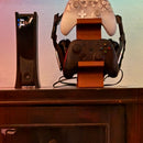 ORANGE 3-in-1 PS5 and Xbox Controller Stand – Compatible with PlayStation 5/Xbox Consoles. A gaming desktop organizer with a headphone hanger, non-charging base that holds 2 controllers and headphones. Space-saving white/black console accessory.