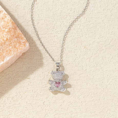 A delicate and adorable pink heart-shaped bear pendant copper necklace, adorned with synthetic zirconia, paired with a stainless steel chain, decorated with synthetic zirconia, perfect as a daily jewelry gift or a sweet and cute party accessory.（gold））