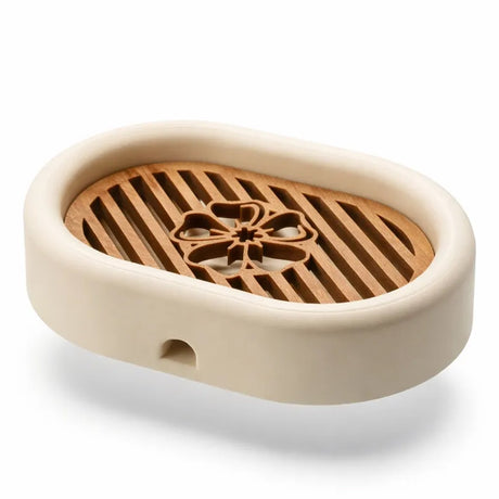 3D-printed oval soap dish with drain rack, white and wood-look.