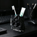 3D-printed hooded skull organizer, perfect for storing toothbrushes and toothpaste in your bathroom. Black.