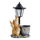 Solar Simulation Rabbit Ornament, charges by day and lights up automatically at night, three rabbits cluster around a street lamp with "WELCOME" bucket, warmly decorates courtyard and balcony, eco-friendly and healing./Resin flowerpot rabbit