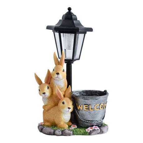 Solar Simulation Rabbit Ornament, charges by day and lights up automatically at night, three rabbits cluster around a street lamp with 