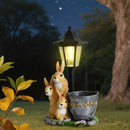 Solar Simulation Rabbit Ornament, charges by day and lights up automatically at night, three rabbits cluster around a street lamp with "WELCOME" bucket, warmly decorates courtyard and balcony, eco-friendly and healing./Resin flowerpot rabbit