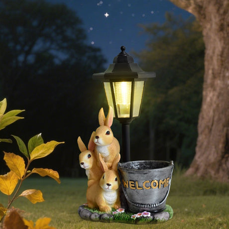 Solar Simulation Rabbit Ornament, charges by day and lights up automatically at night, three rabbits cluster around a street lamp with 