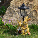Solar Simulation Rabbit Ornament, charges by day and lights up automatically at night, three rabbits cluster around a street lamp with "WELCOME" bucket, warmly decorates courtyard and balcony, eco-friendly and healing./Resin flowerpot rabbit