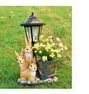 Solar Simulation Rabbit Ornament, charges by day and lights up automatically at night, three rabbits cluster around a street lamp with "WELCOME" bucket, warmly decorates courtyard and balcony, eco-friendly and healing./Resin flowerpot rabbit